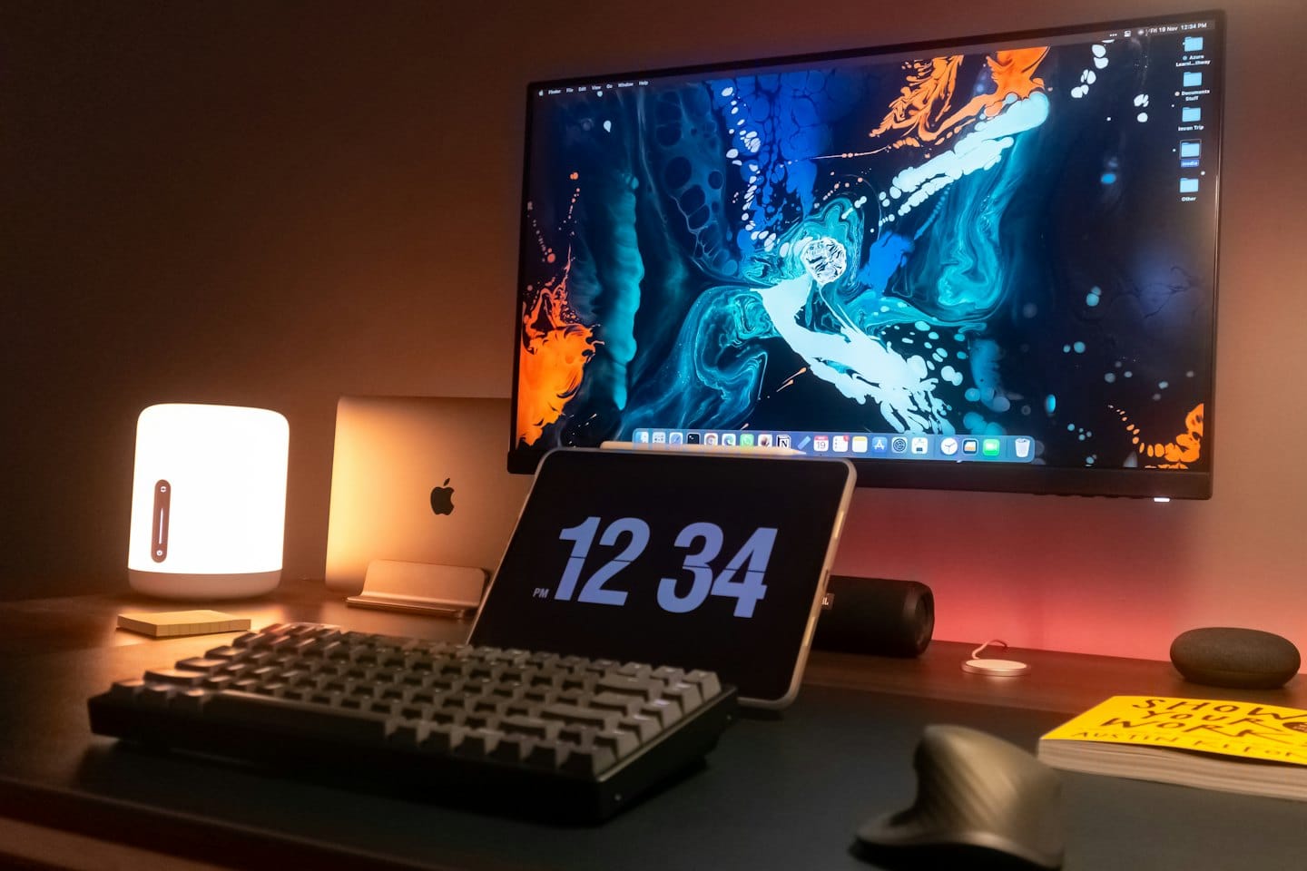 Modern computer equipment arranged on a wooden office desk.